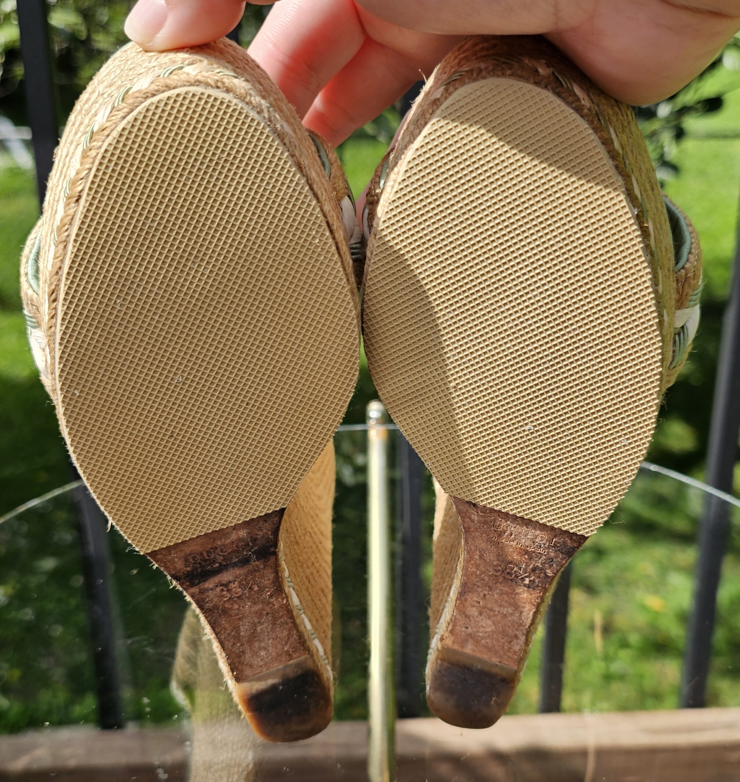 Rubber soles of the Gucci mint green espadrille wedge sandals shown for wear