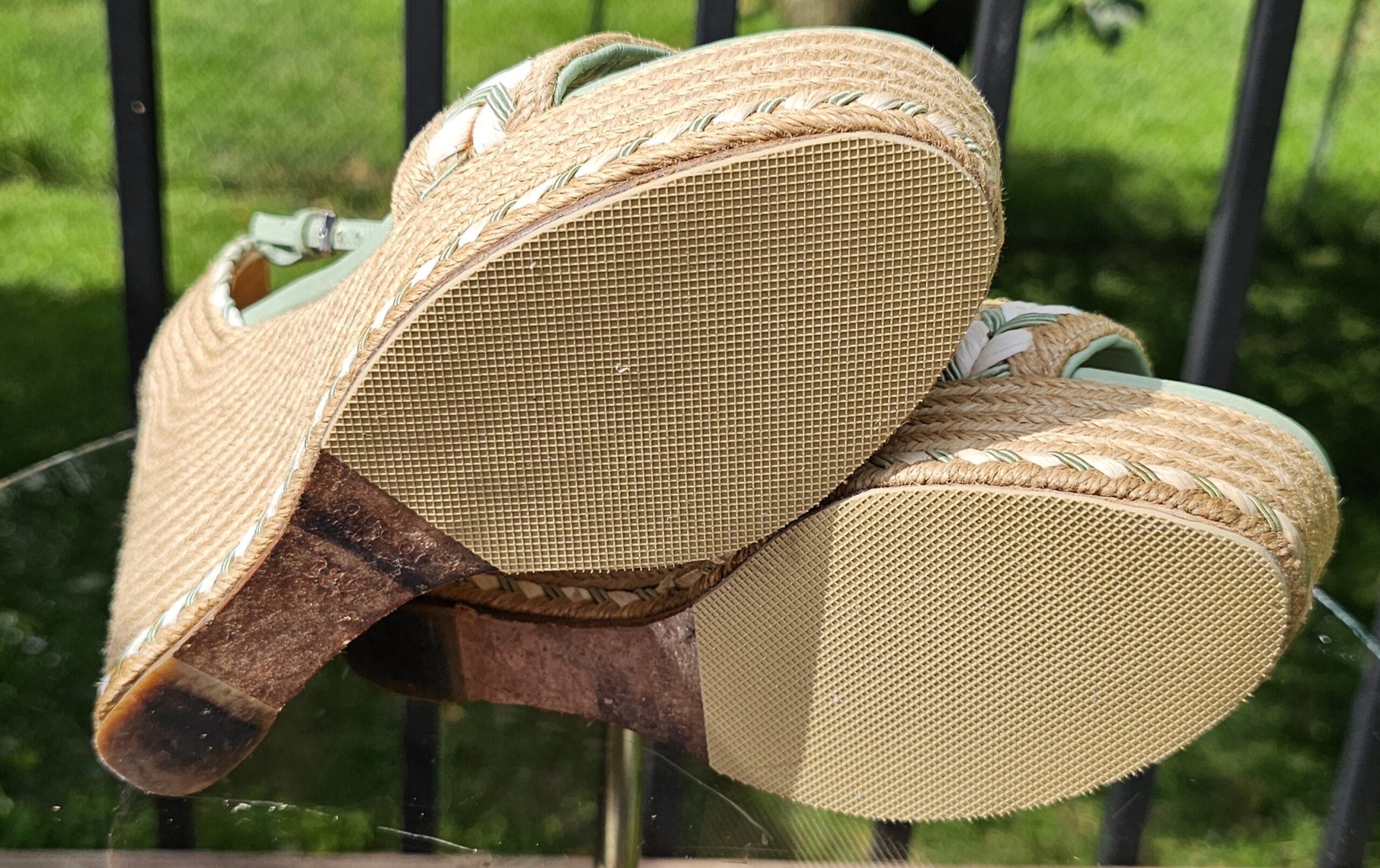 Soles and jute wedge edges of the Gucci espadrille wedge sandals showing normal wear from use