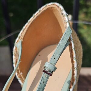Inside of the Gucci mint green espadrille wedge sandal showing the leather lining and ankle strap