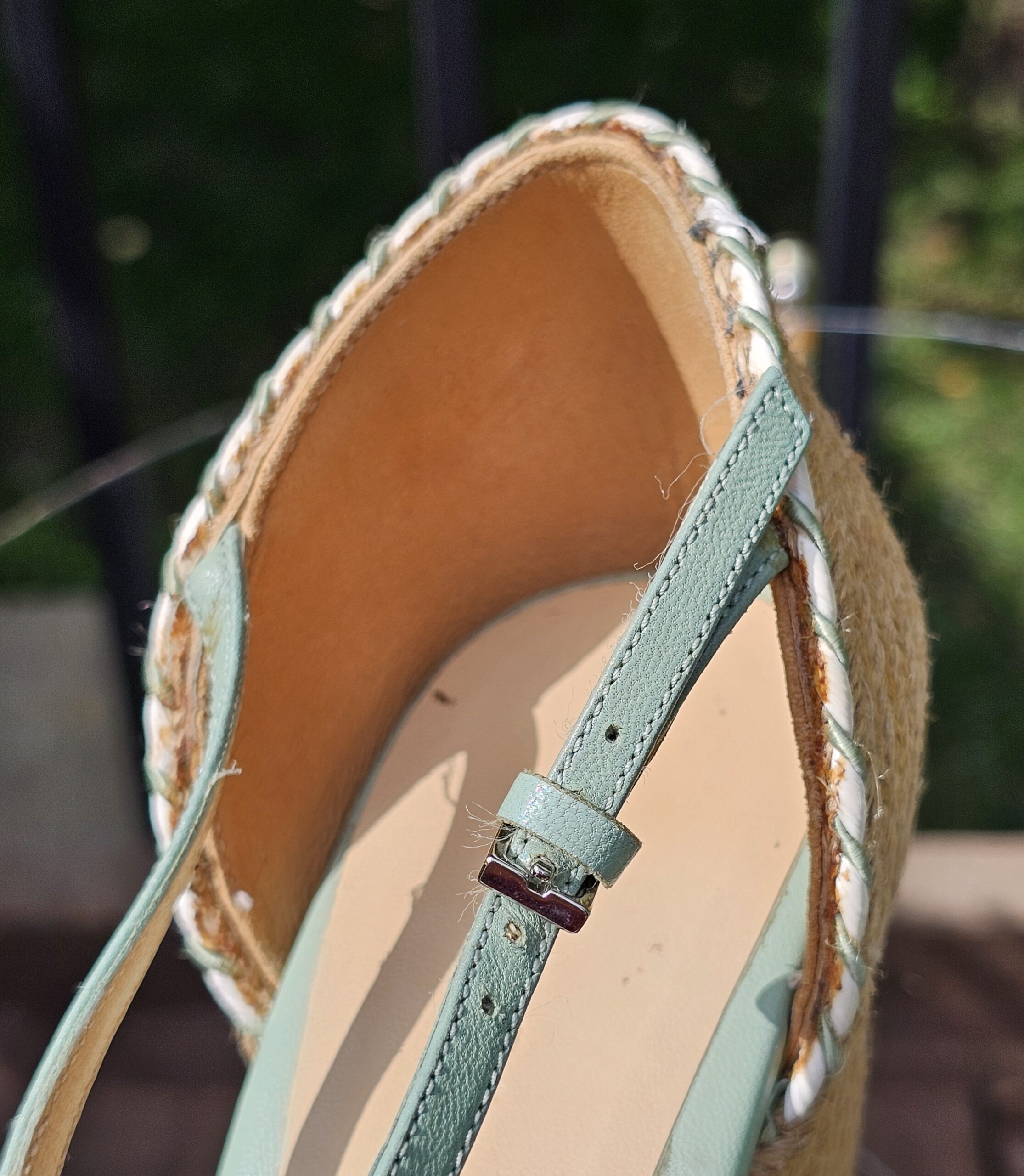 Inside of the Gucci mint green espadrille wedge sandal showing the leather lining and ankle strap