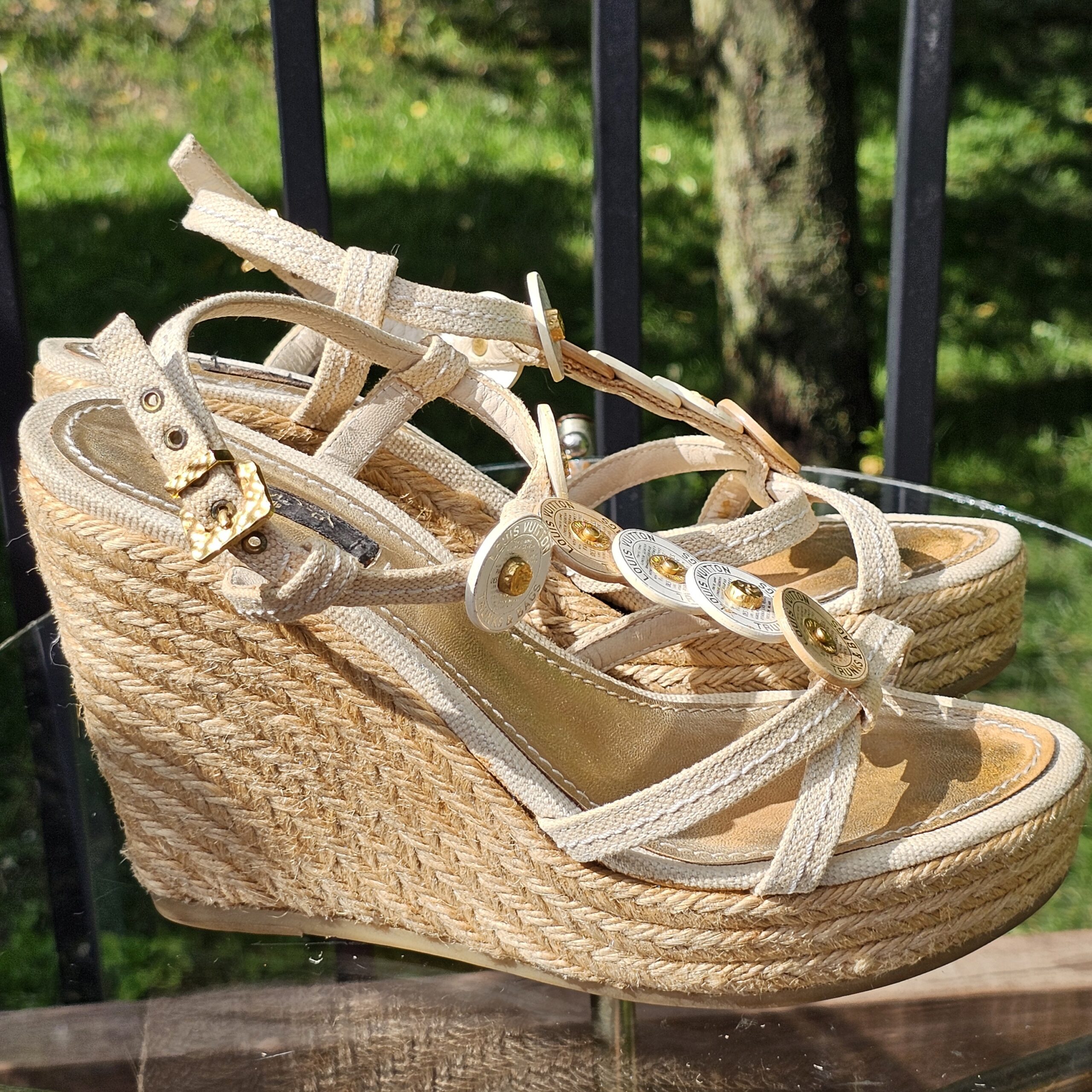 Side profile of the Louis Vuitton Trunks and Bags espadrille wedge sandal showing the woven jute wedge