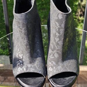 Front view of the pair of Chanel lace-pattern peep toe ankle booties showing the open toes
