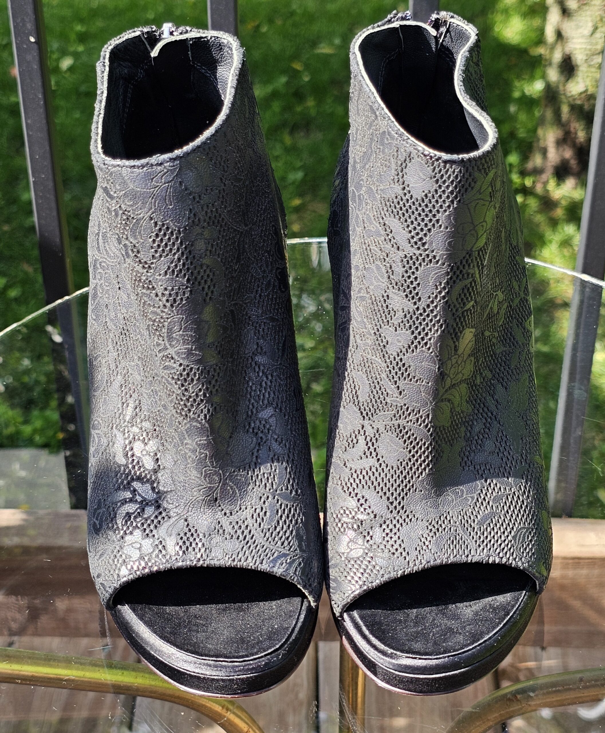 Front view of the pair of Chanel lace-pattern peep toe ankle booties showing the open toes