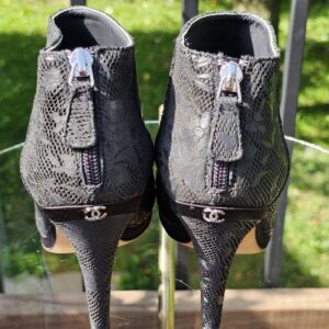 Back of the Chanel peep toe ankle booties showing the zip closures and silver-tone CC detail at the heels