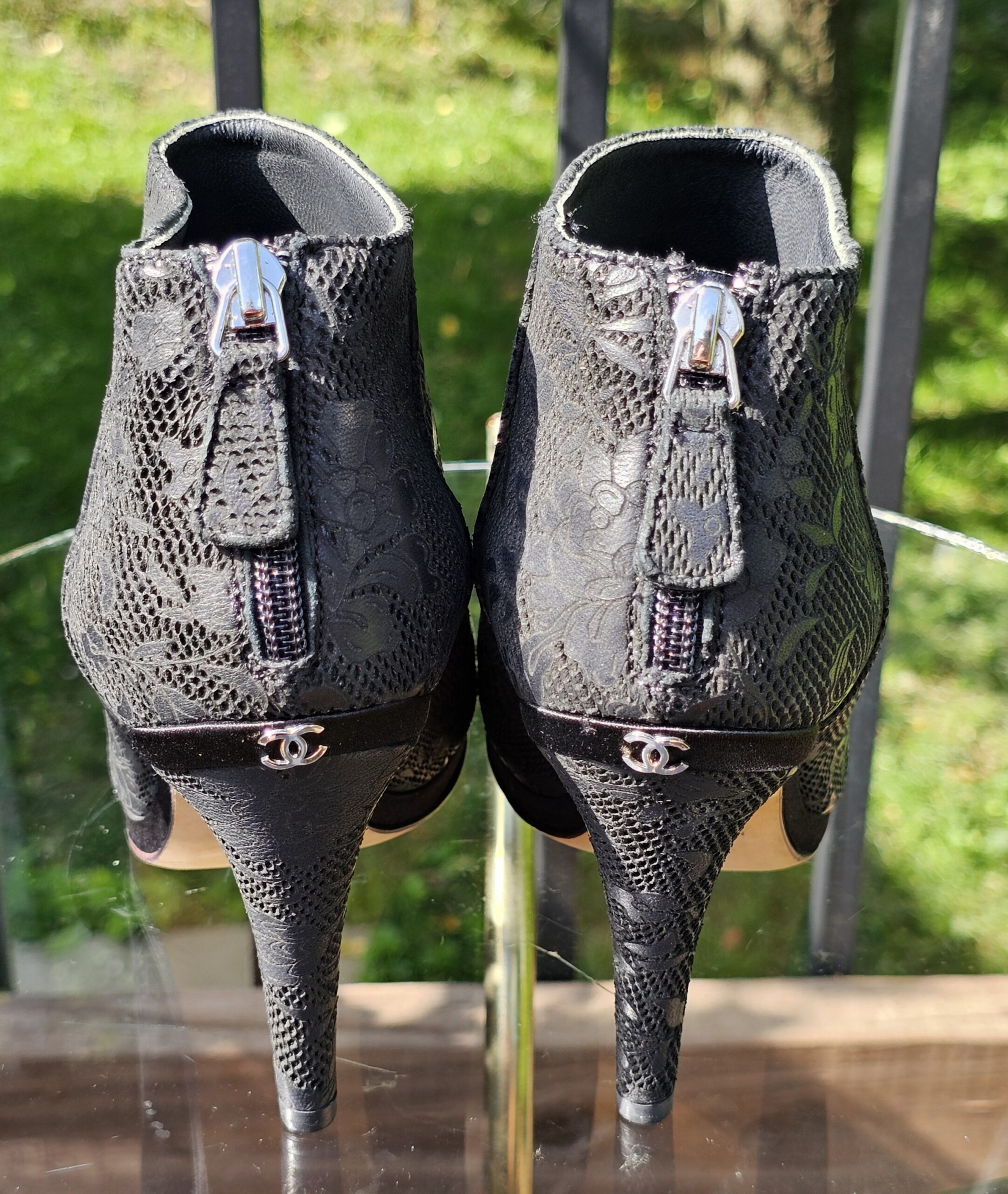 Back of the Chanel peep toe ankle booties showing the zip closures and silver-tone CC detail at the heels