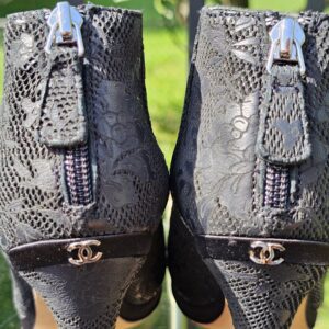 Close-up of the silver-tone CC logos at the back heels of the Chanel lace peep toe ankle booties