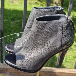 Side profile of the Chanel lace-pattern peep toe ankle bootie showing the heel height