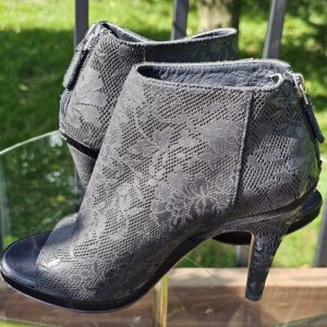 Angled view of the Chanel lace peep toe ankle booties showing the shaft and slim heel