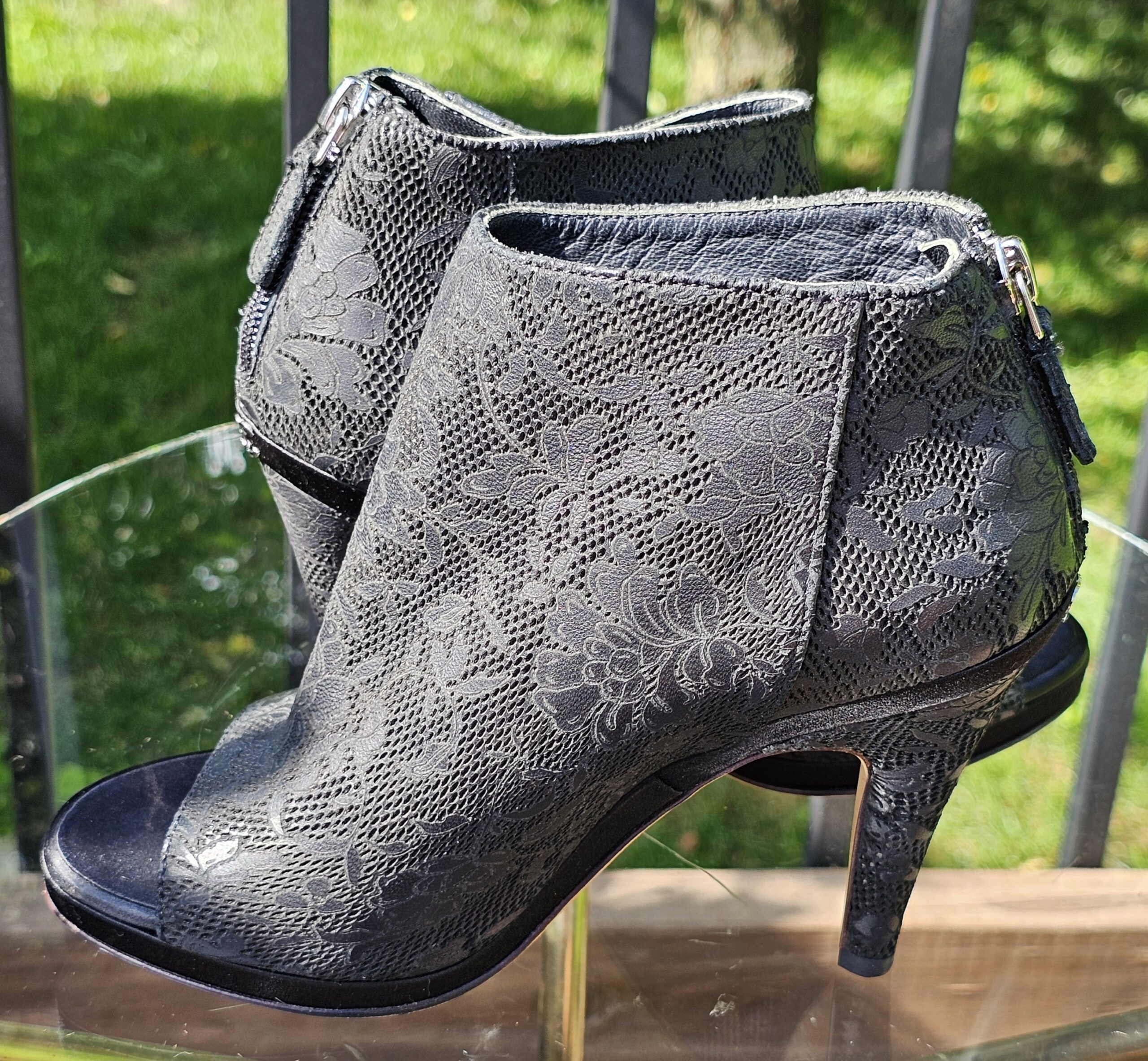 Angled view of the Chanel lace peep toe ankle booties showing the shaft and slim heel
