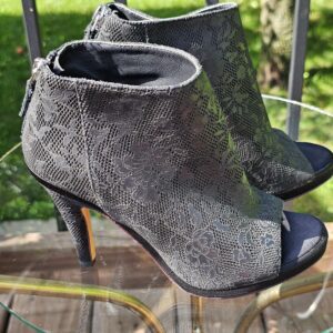 Chanel lace-pattern peep toe ankle bootie showing the ankle shaft and back zip
