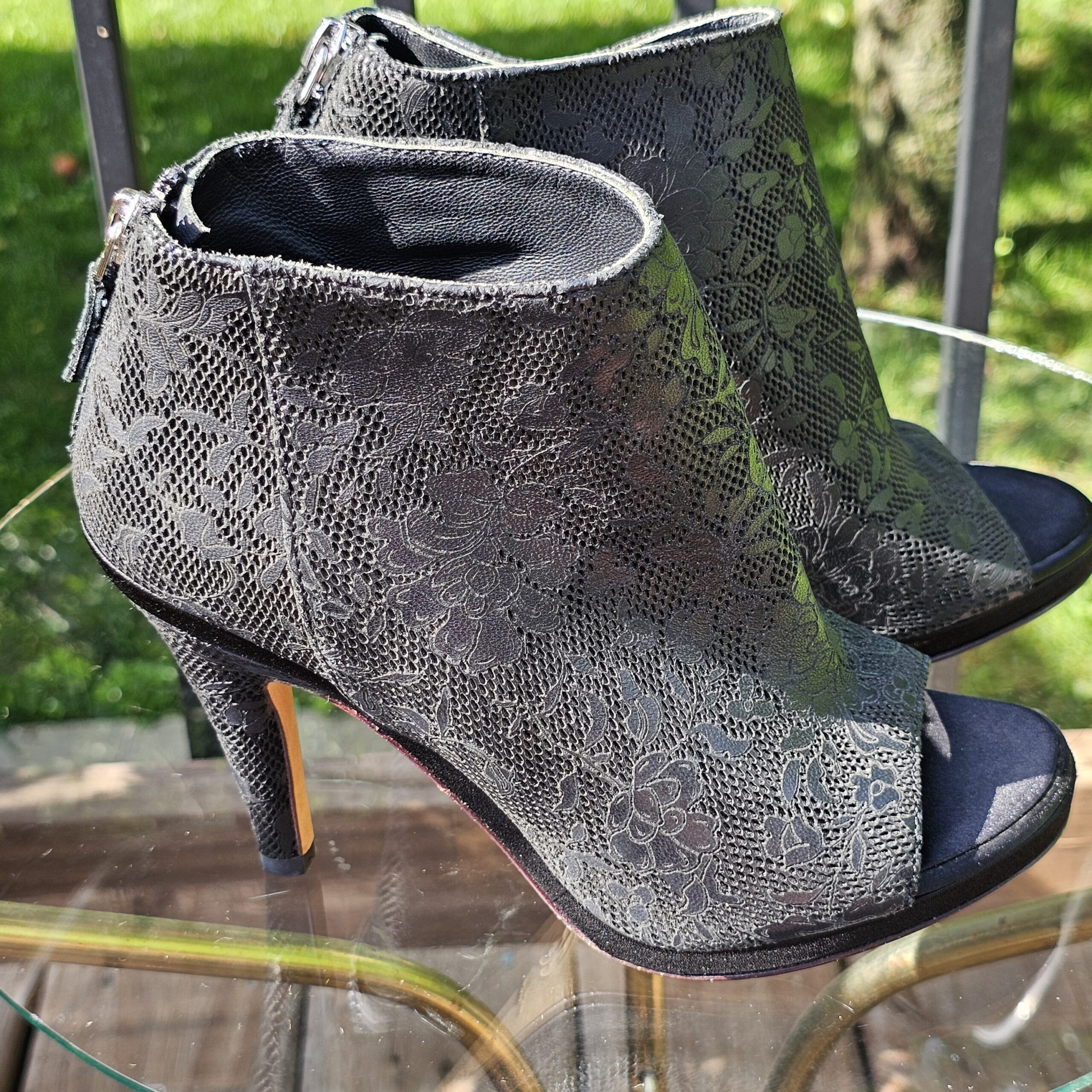 Chanel lace-pattern peep toe ankle bootie showing the ankle shaft and back zip