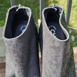 Chanel peep toe ankle booties photographed from above showing the interiors and lace-pattern leather