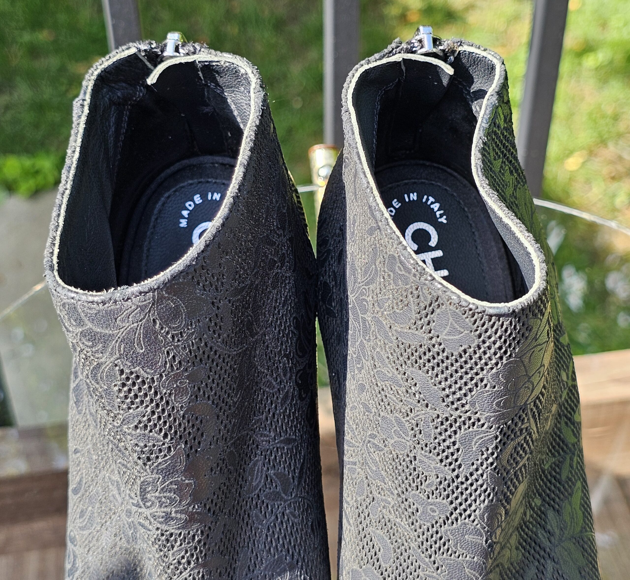 Chanel peep toe ankle booties photographed from above showing the interiors and lace-pattern leather