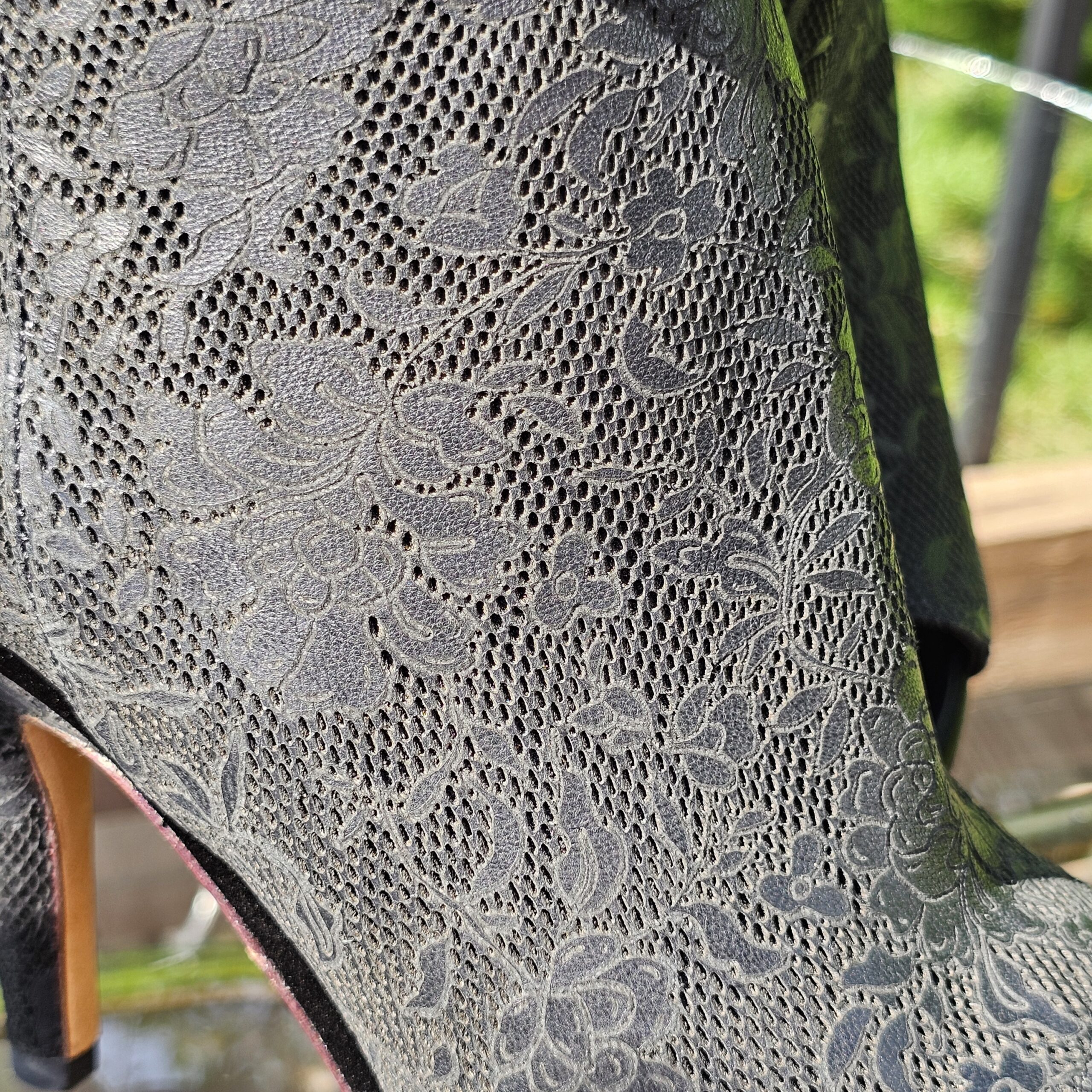 Close-up of the floral lace-pattern leather on the Chanel peep toe ankle booties