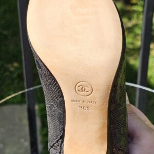 Leather sole of the Chanel lace peep toe ankle bootie shown for condition