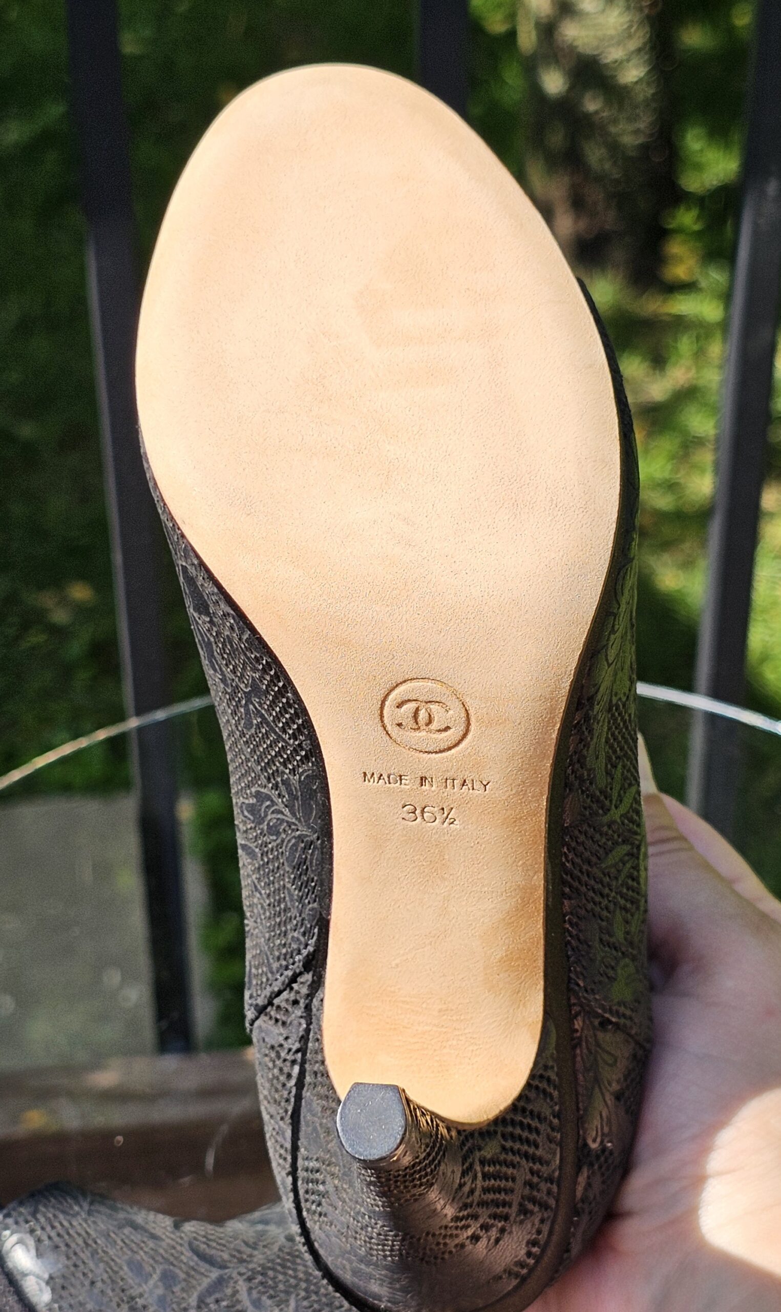 Leather sole of the Chanel lace peep toe ankle bootie shown for condition