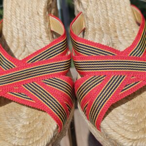 Crossover striped straps across the toe of the Christian Louboutin espadrille wedge sandals
