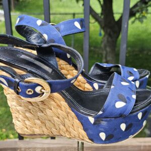 Side profile of the Louis Vuitton printed raffia wedge sandals showing the woven raffia wedge and front platform