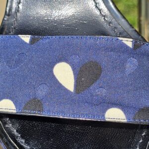 Close-up of the blue printed fabric with cream and black detailing on the Louis Vuitton raffia wedge sandals