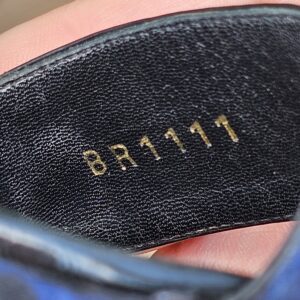 Serial marking BR1111 stamped on the leather insole of the Louis Vuitton printed raffia wedge sandals