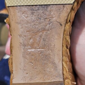 Close-up of the sole of the Louis Vuitton printed raffia wedge sandal showing considerable wear from use
