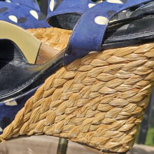 Black leather footbed and raffia wedge of the Louis Vuitton printed sandals shown for condition