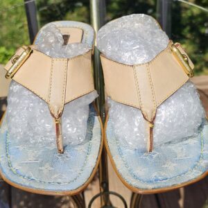 Top view of both Louis Vuitton Monogram denim thong sandals showing the leather T-straps and gold-tone hardware
