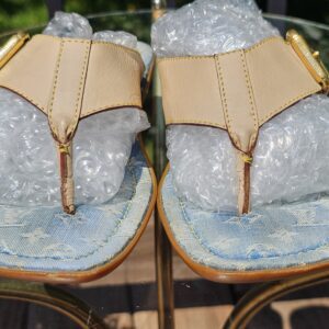 Front view of the Louis Vuitton Monogram denim thong sandals showing the toe posts and leather straps