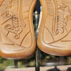 Close-up of the Louis Vuitton embossed leather soles showing normal wear from use
