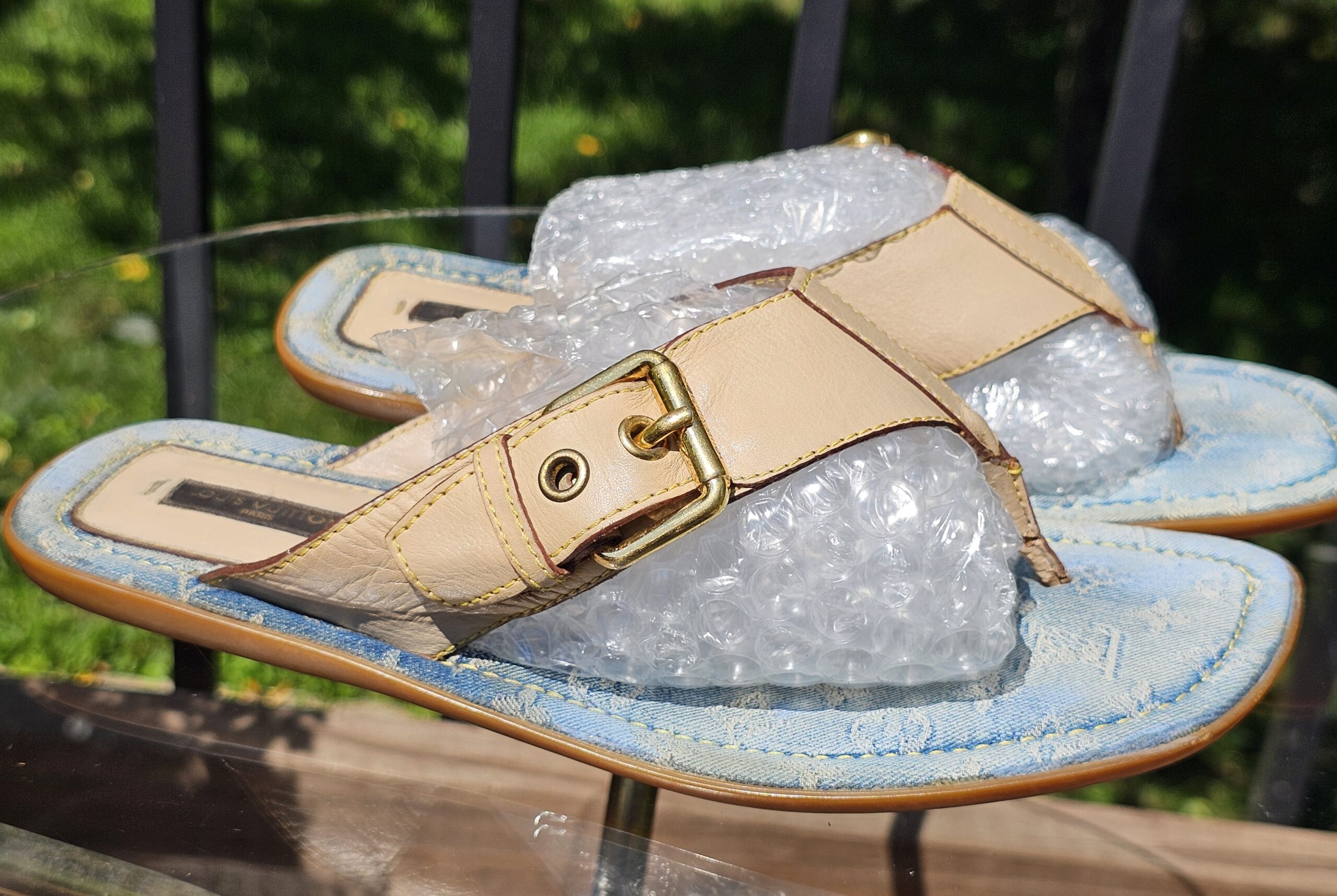 Natural leather strap and gold-tone buckle across the Louis Vuitton Monogram denim thong sandal