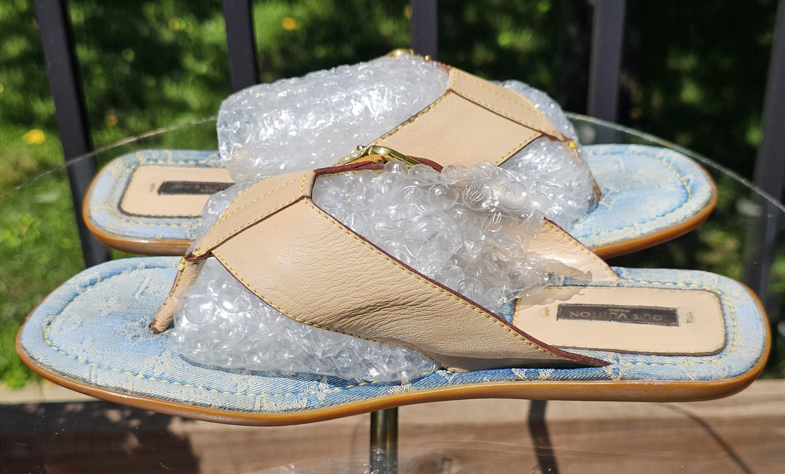 Side view of the Louis Vuitton Monogram denim thong sandals showing the flat denim footbed