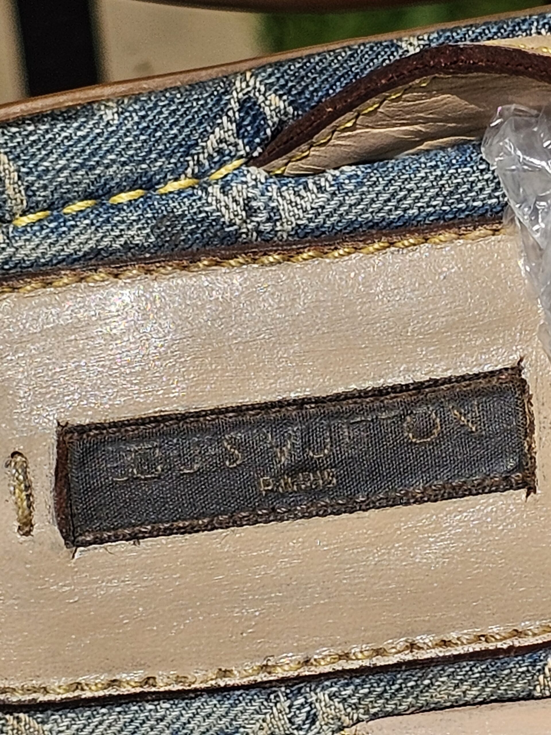 Louis Vuitton Paris label stitched onto the denim footbed of the thong sandals