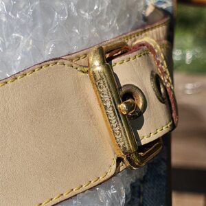 Close-up of the gold-tone buckle hardware on the Louis Vuitton Monogram denim thong sandals showing surface wear