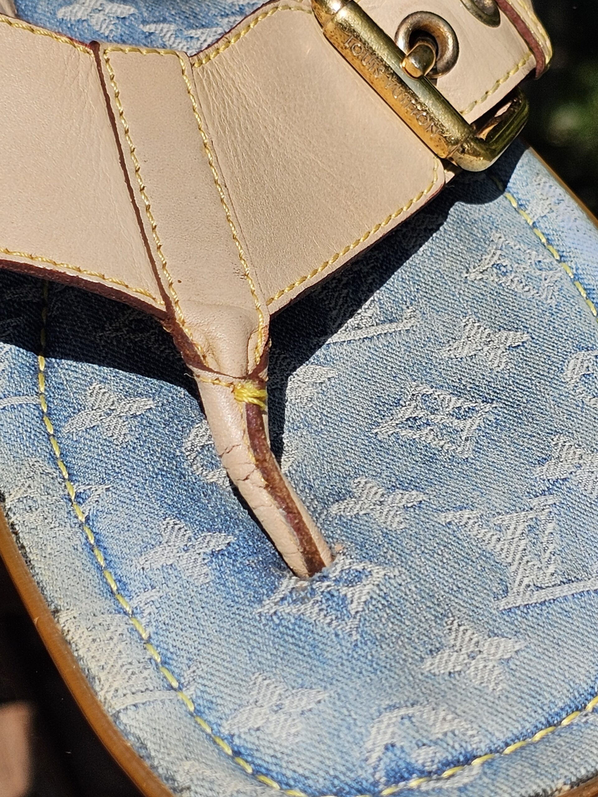 Close-up of the light blue Monogram denim footbed and leather toe post on the Louis Vuitton thong sandals