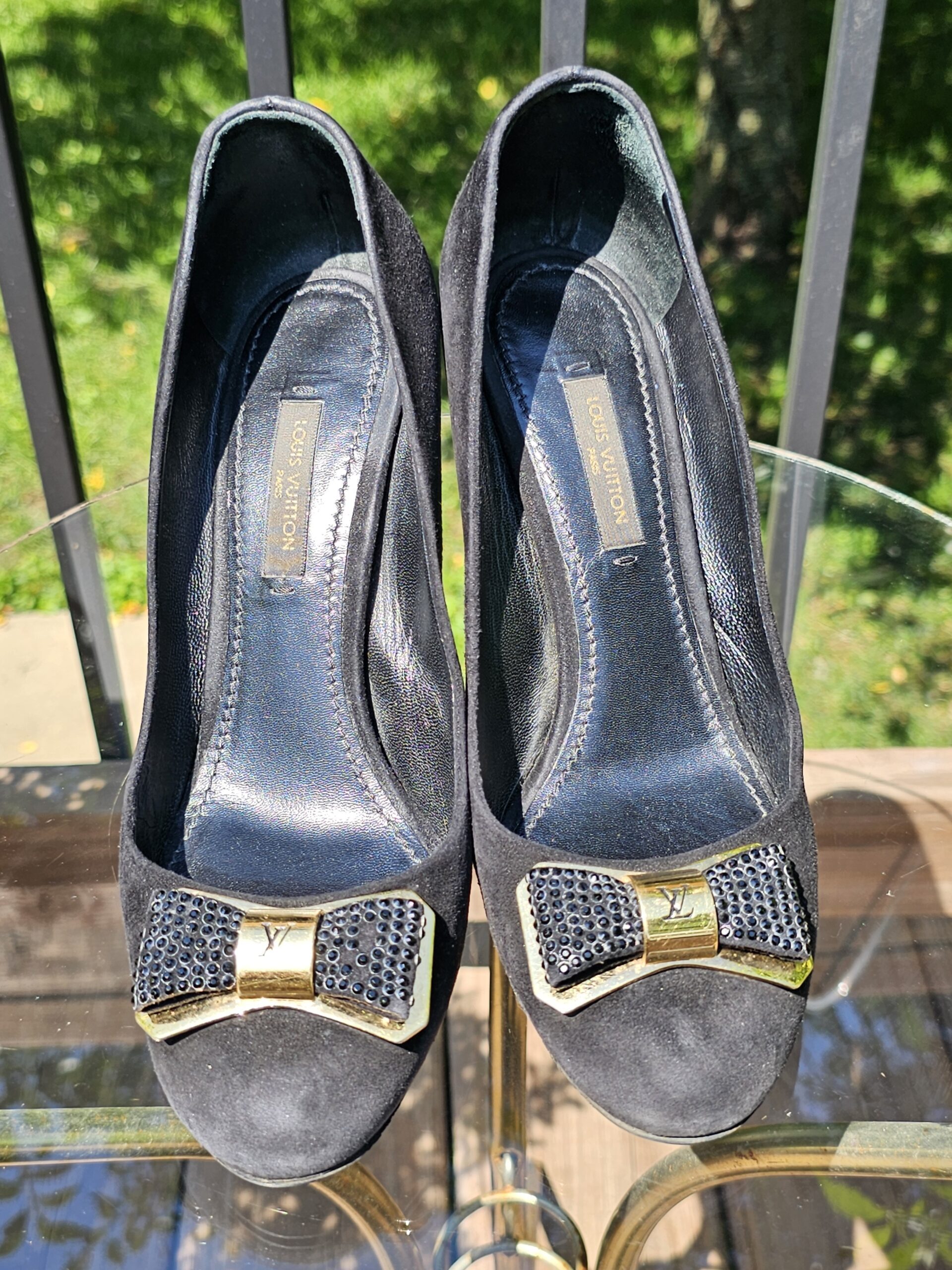 Top view of both Louis Vuitton crystal embellished bow suede pumps showing the peep toes and bow detail