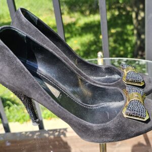 Side view of the Louis Vuitton crystal embellished bow suede pumps showing the heel height and suede upper