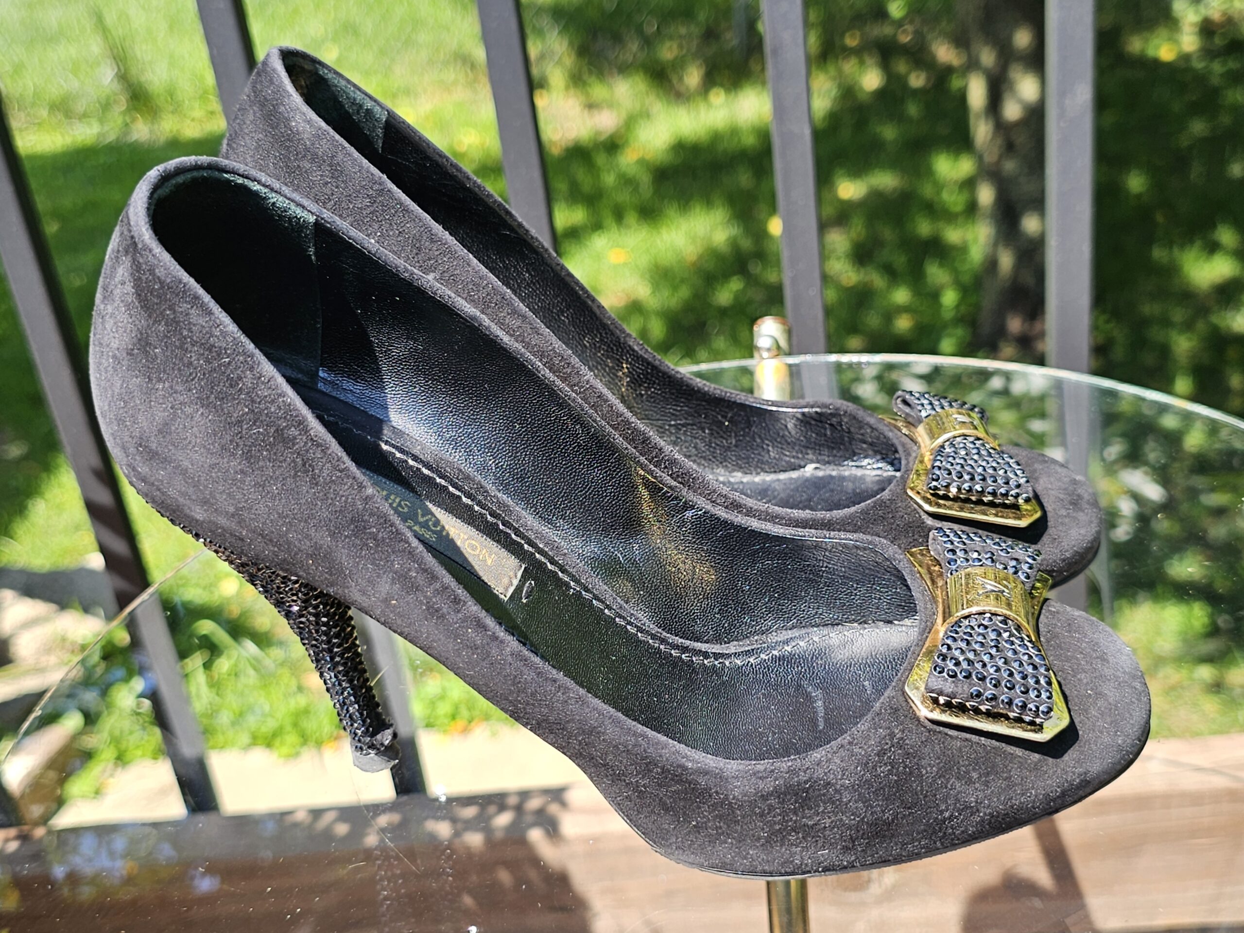 Side view of the Louis Vuitton crystal embellished bow suede pumps showing the heel height and suede upper