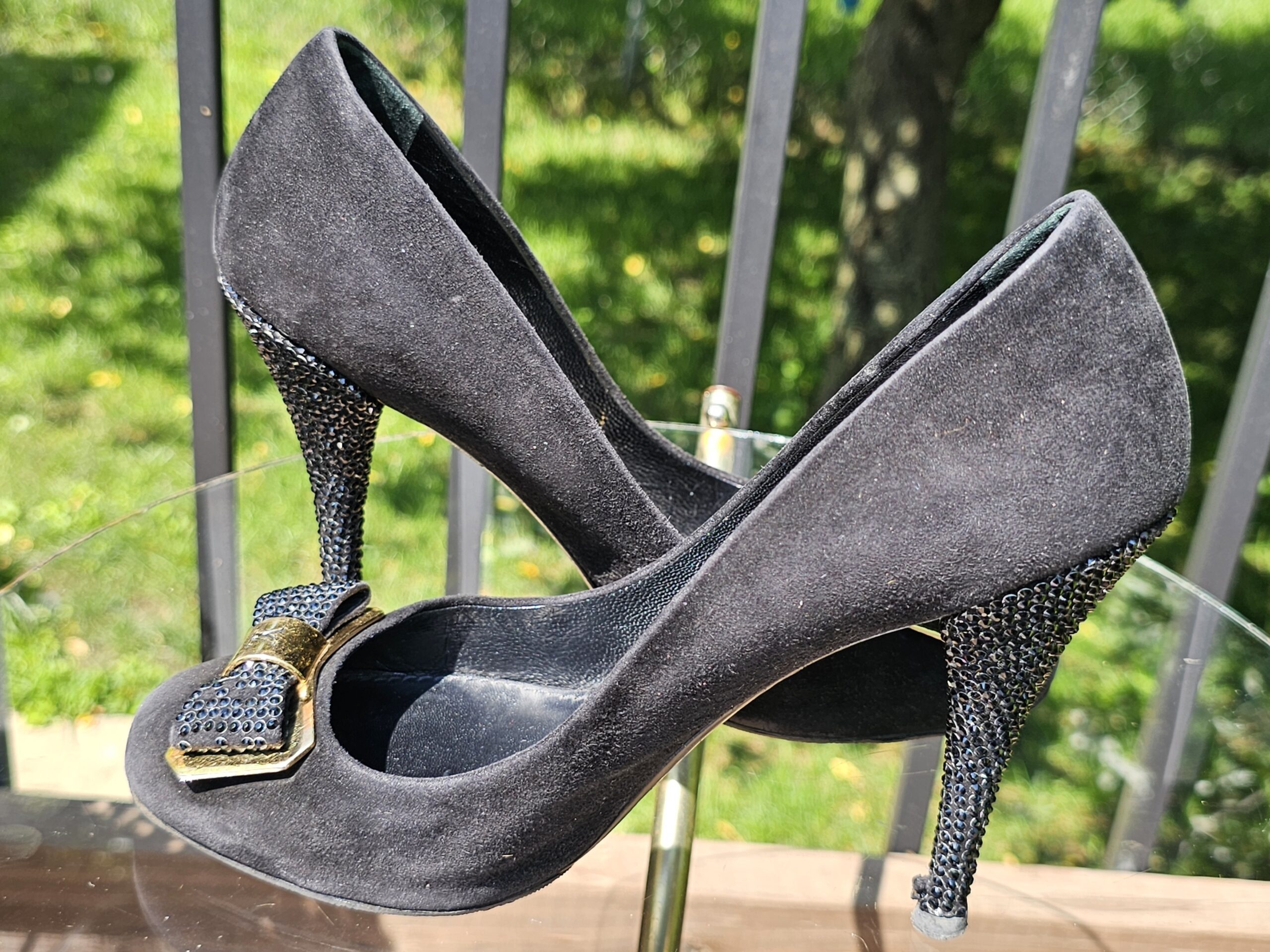 Angled view of the Louis Vuitton crystal embellished bow suede pumps with the crystal heel in profile