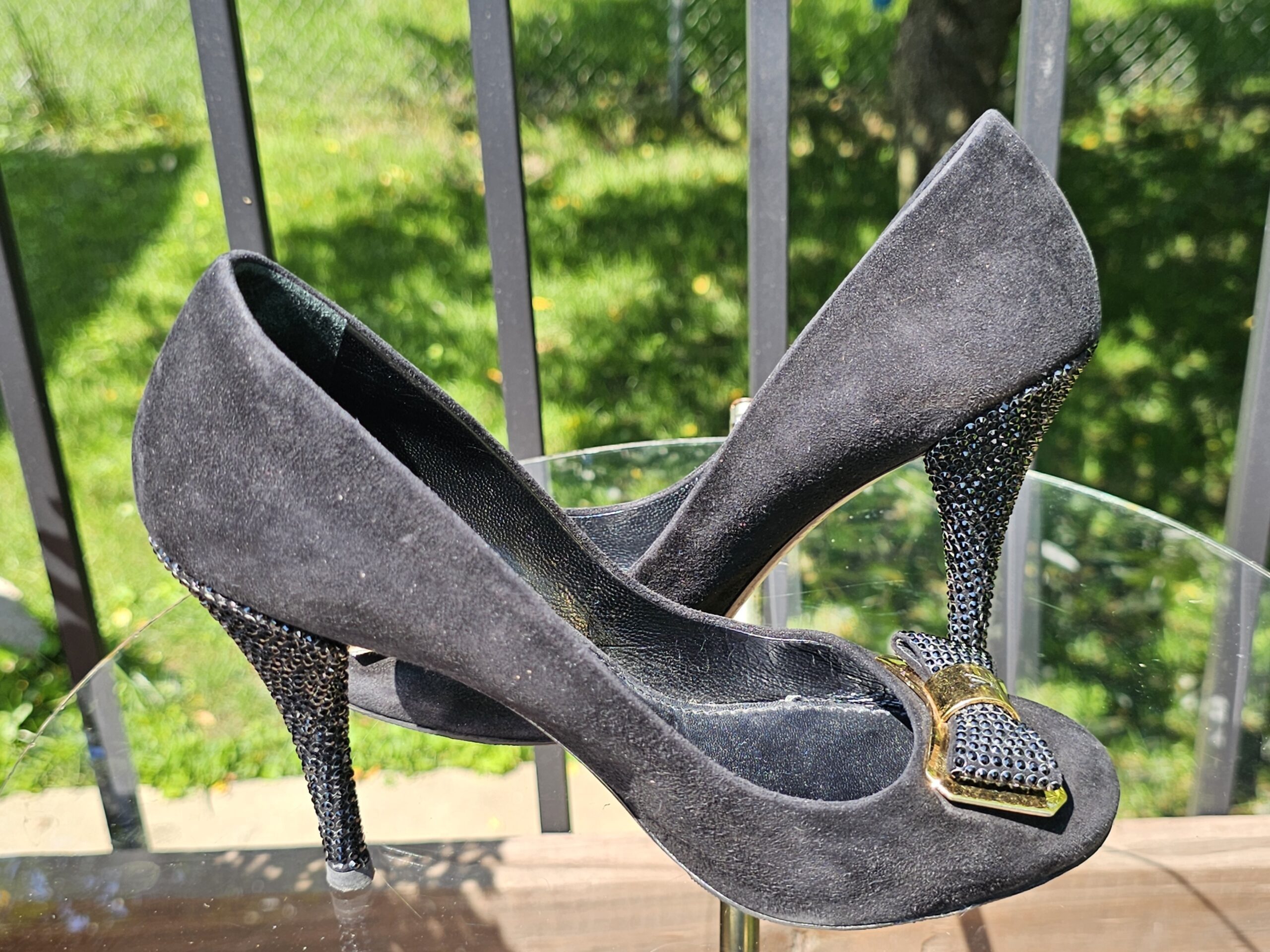 Pair of Louis Vuitton crystal embellished bow suede pumps shown from the side