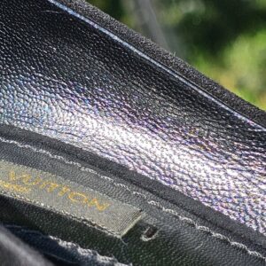 Louis Vuitton stamp inside the lining of the crystal embellished bow suede pumps