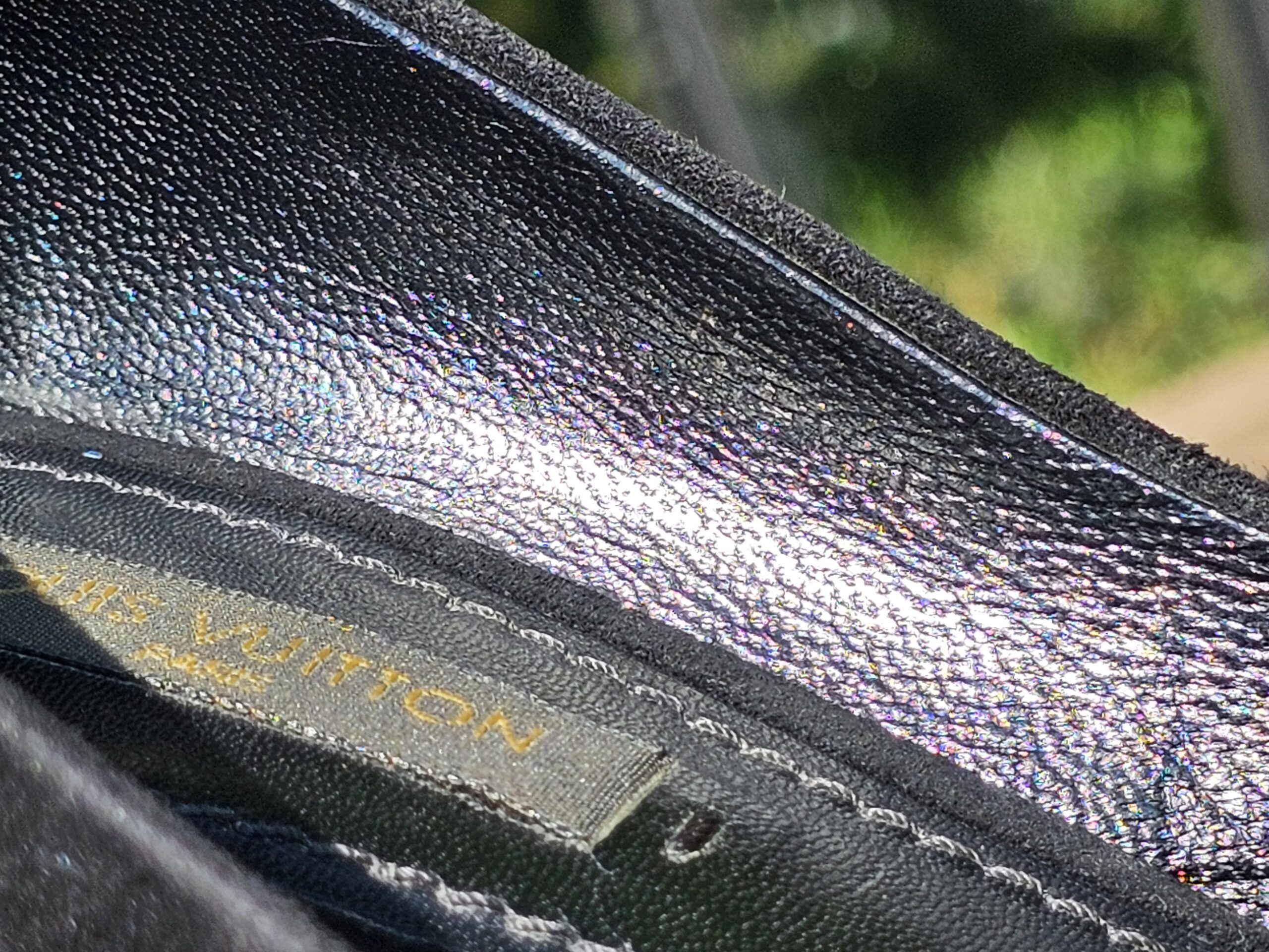 Louis Vuitton stamp inside the lining of the crystal embellished bow suede pumps