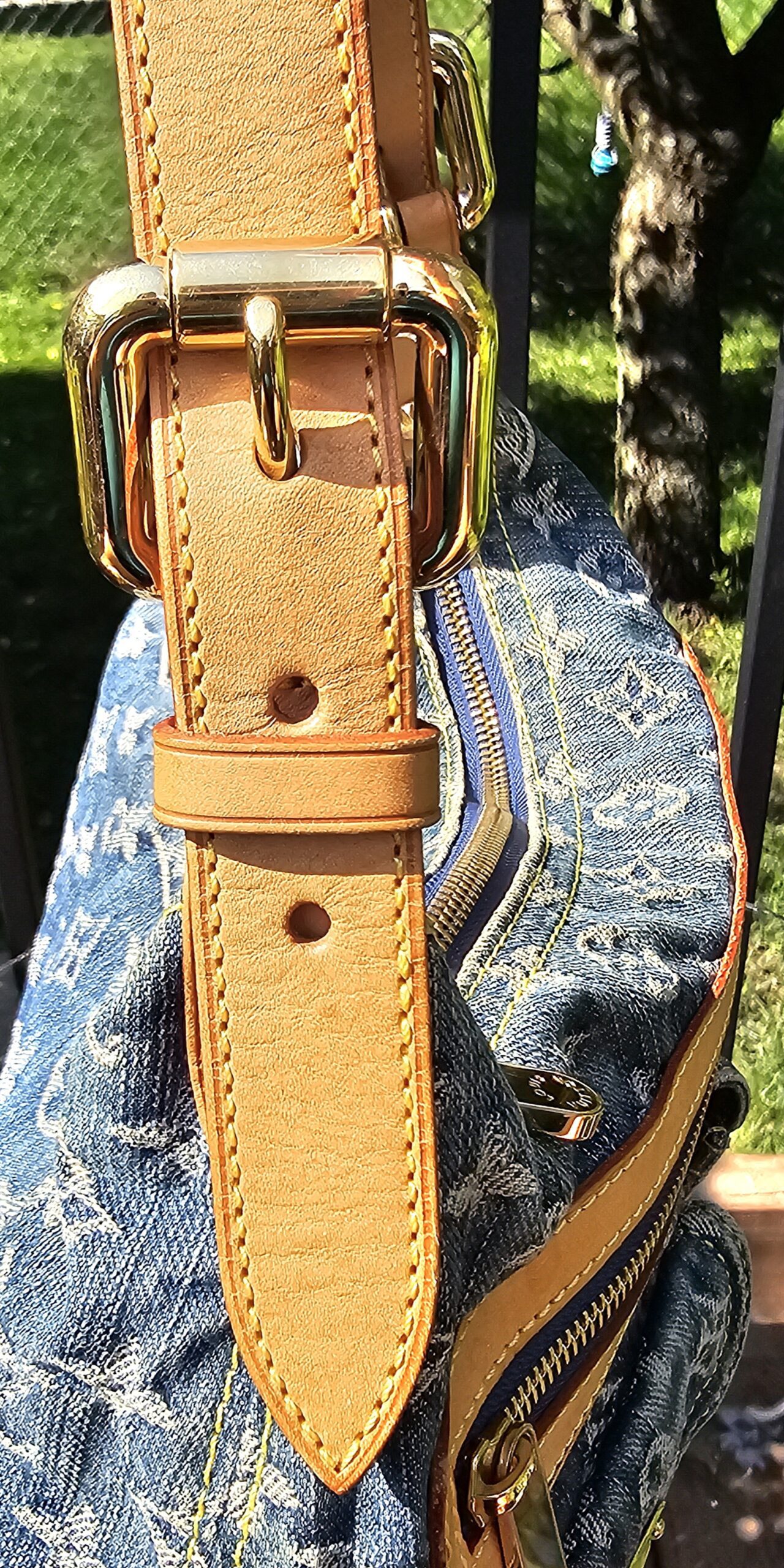Gold-tone buckle on the adjustable strap of the Louis Vuitton Monogram Denim Baggy PM