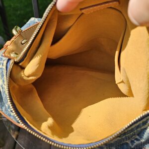 Interior of the Louis Vuitton Monogram Denim Baggy PM lined in yellow alcantara style fabric