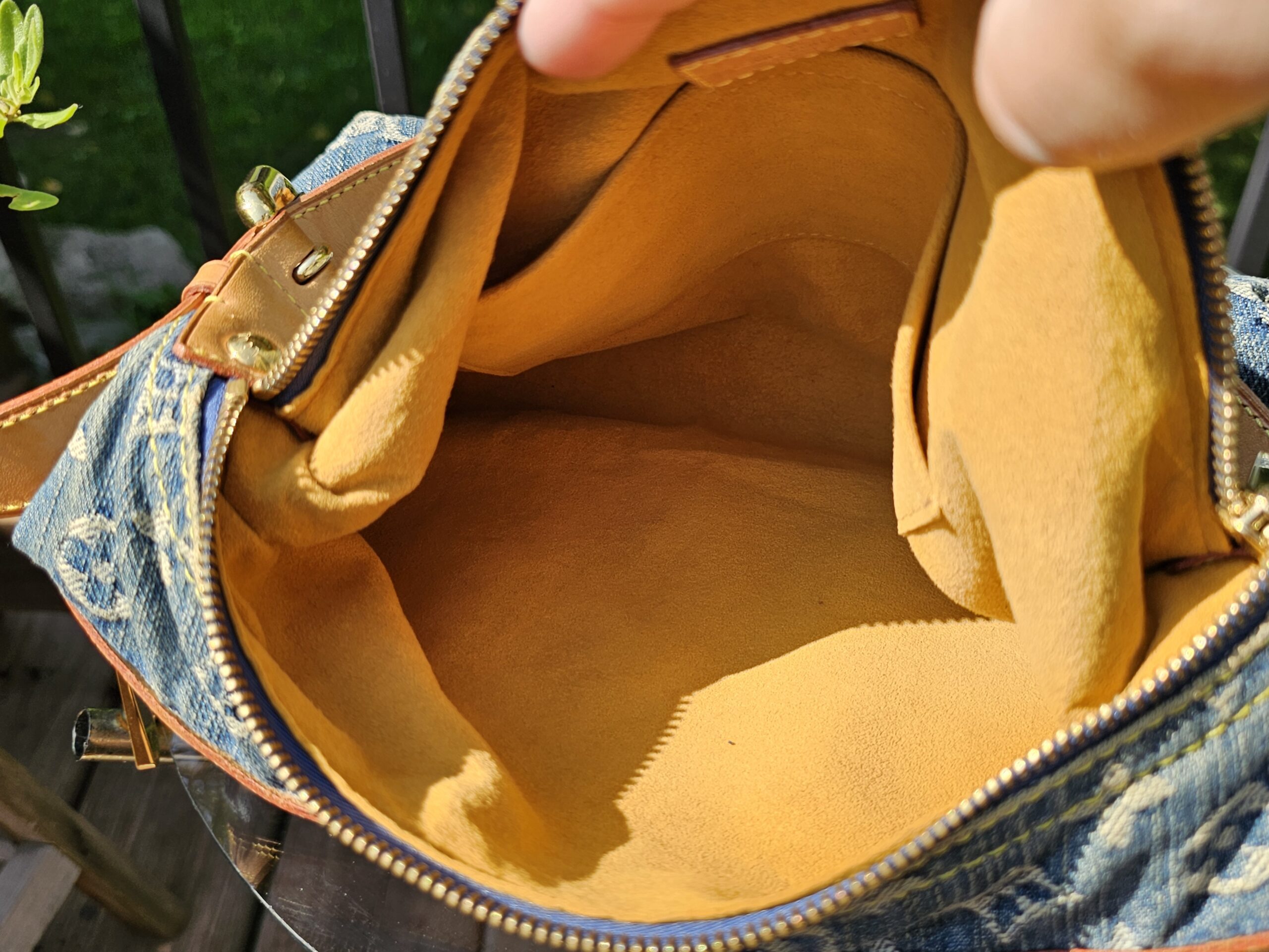 Interior of the Louis Vuitton Monogram Denim Baggy PM lined in yellow alcantara style fabric