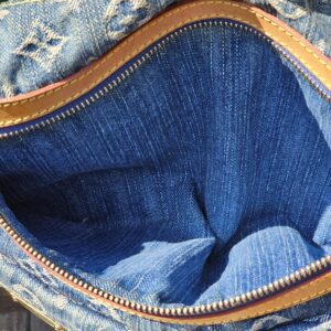 Open zip top of the Louis Vuitton Monogram Denim Baggy PM showing the denim exterior and lined interior