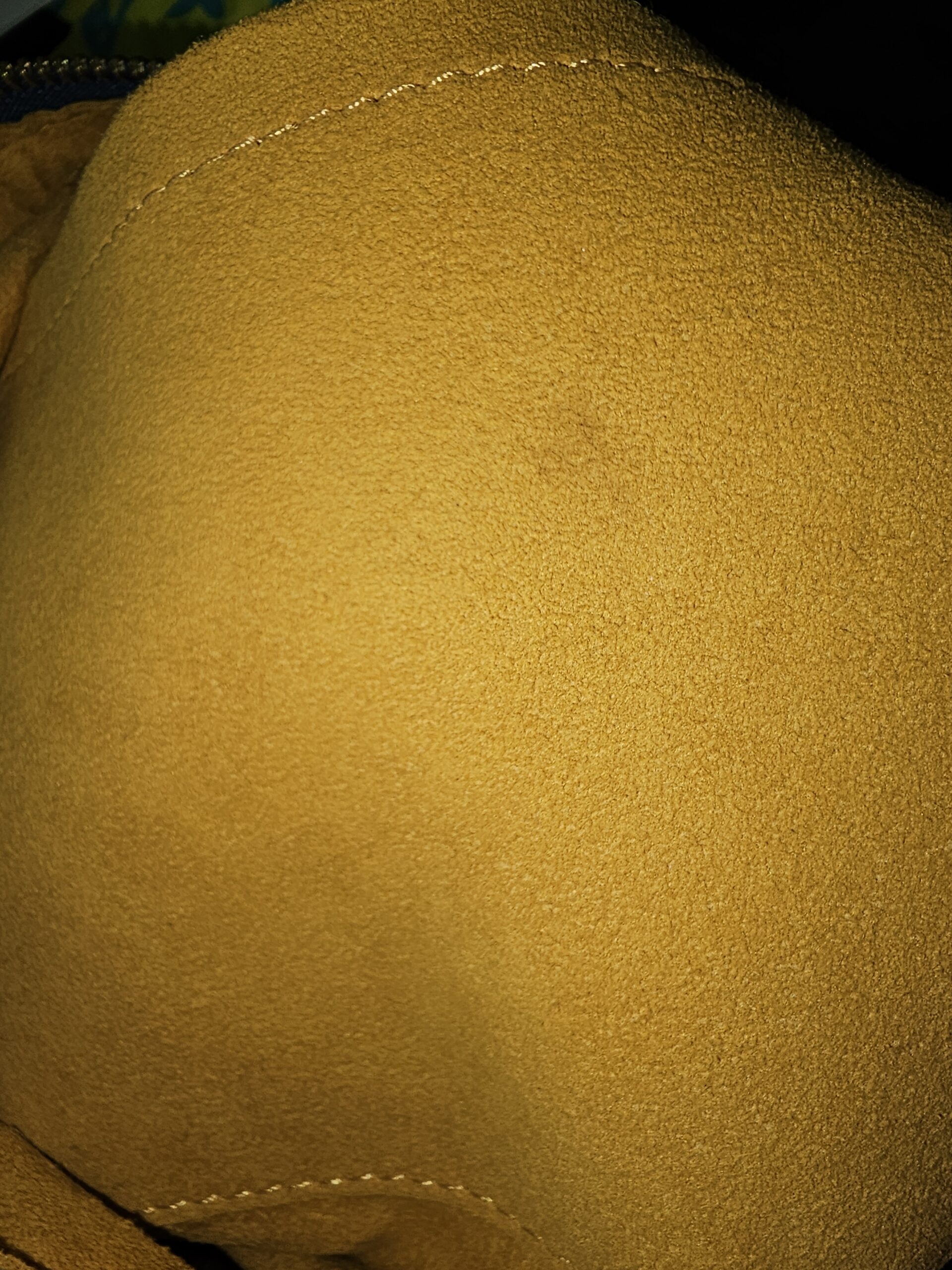 Close-up of the yellow alcantara style lining inside the Louis Vuitton Monogram Denim Baggy PM