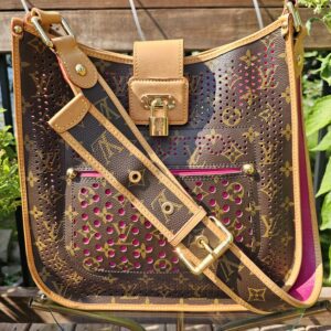 Louis Vuitton Monogram Perforated Musette in fuchsia with the adjustable Monogram strap laid across the front