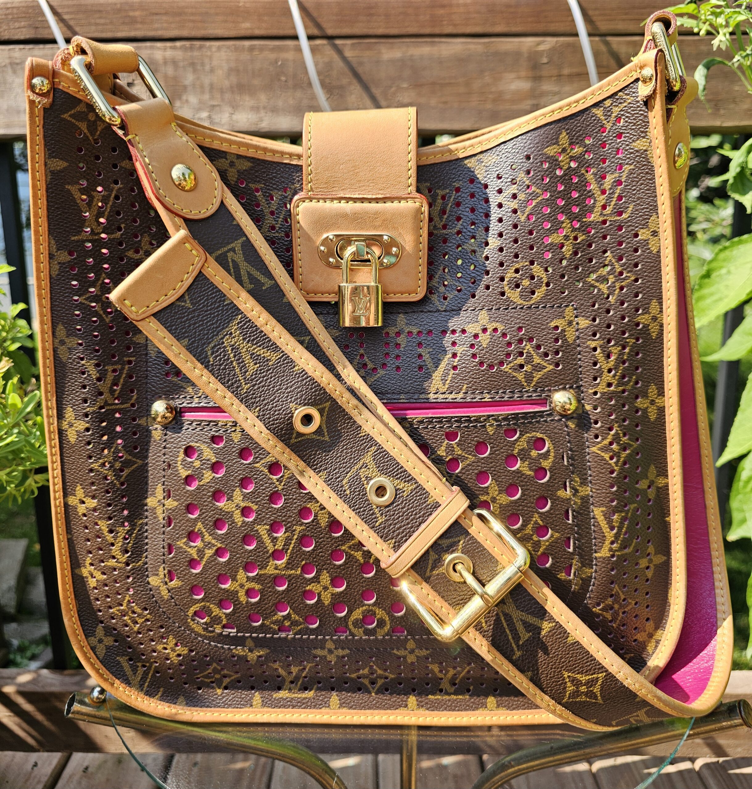 Louis Vuitton Monogram Perforated Musette in fuchsia with the adjustable Monogram strap laid across the front