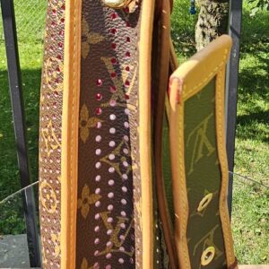 Monogram canvas shoulder strap and vachetta flap of the Louis Vuitton Perforated Musette shown from above