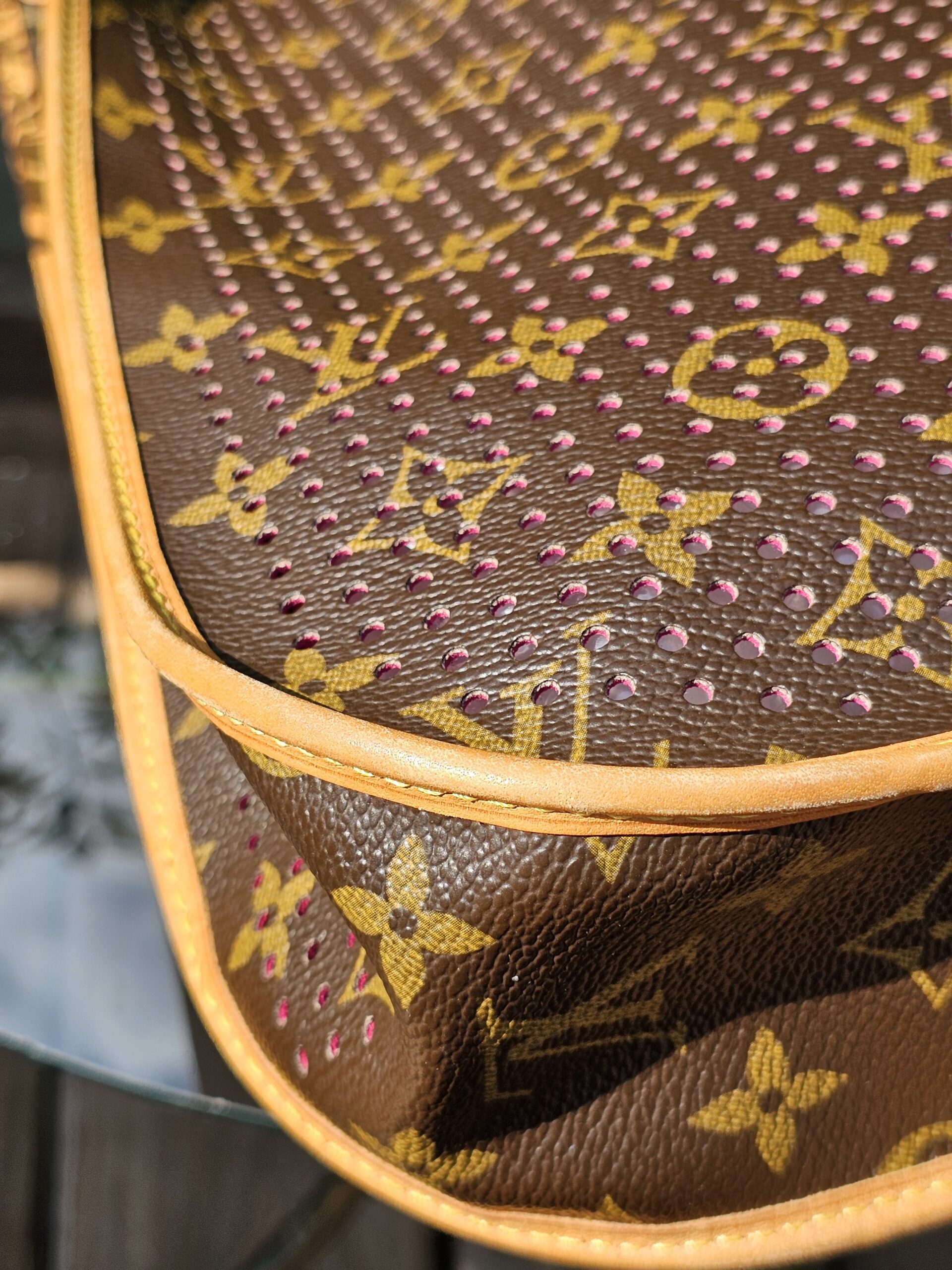 Vachetta trim on the Louis Vuitton Monogram Perforated Musette showing patina and creasing from previous use